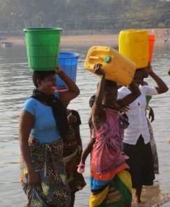 Janepher (left) and the women of the village collect water for the nursery