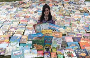 Hannah Steward surrounded by donated books 