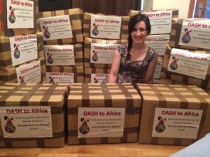 Hannah surrounded by boxes of books for Malawi