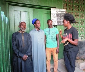 Maimoona talks to the Imam and other village members