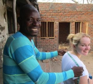 Bryony is measured up by a tailor in Mdala Chikowa