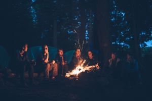 friends around camping fire