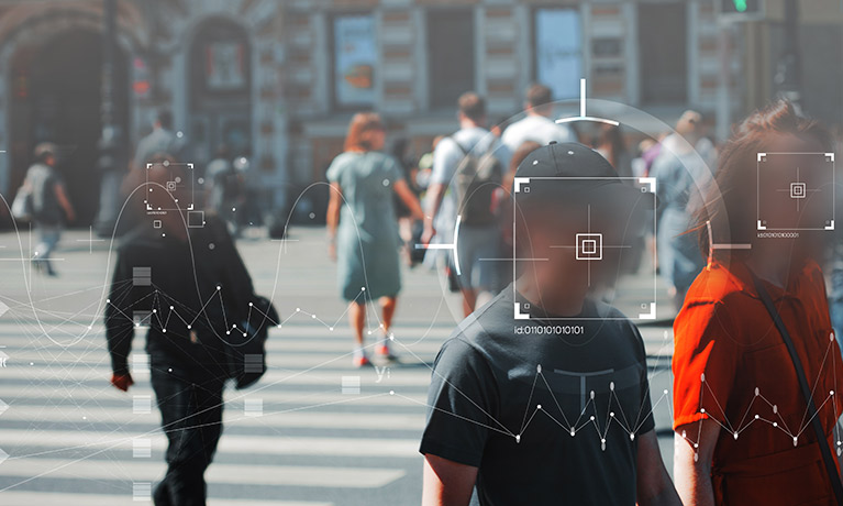 a street scene with people's faces circled by facial recognition softwarre