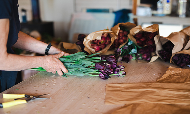 Flowers being arranged on a table