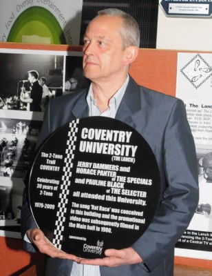 Horace Panter, bass player with The Specials, holds the 2-Tone Trail plaque.