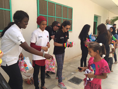 Coventry students handing out clothes and goodie bags to children in the Gaza refugee camp in Jordan