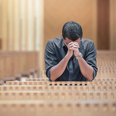 Man-praying-at-church