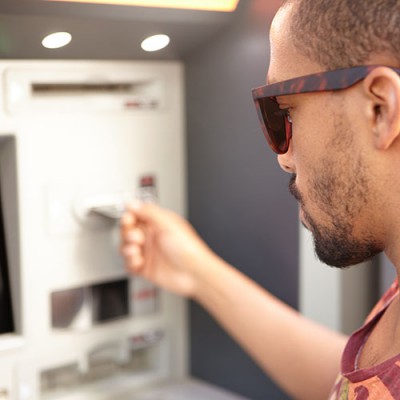 male-student-at-cashpoint