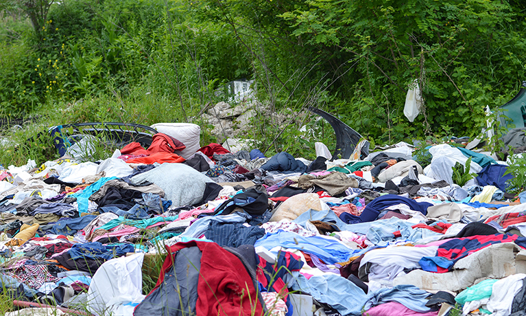 Garbage dump of clothes in nature