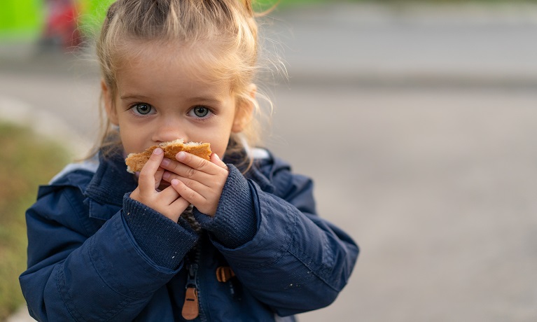 Small child eating some bread